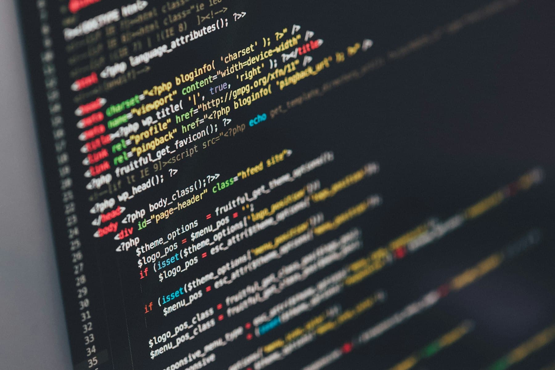 Close-up of code on a dark monitor, the kind of spec an AI agent builder works from